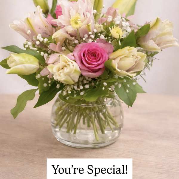 Pink and white bouquet in a clear glass vase with a "You're Special!" card