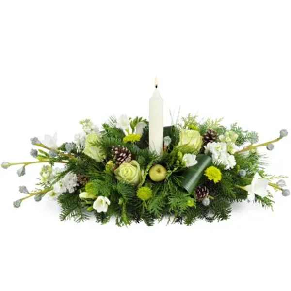 Low floral centerpiece with a white candle and white blooms