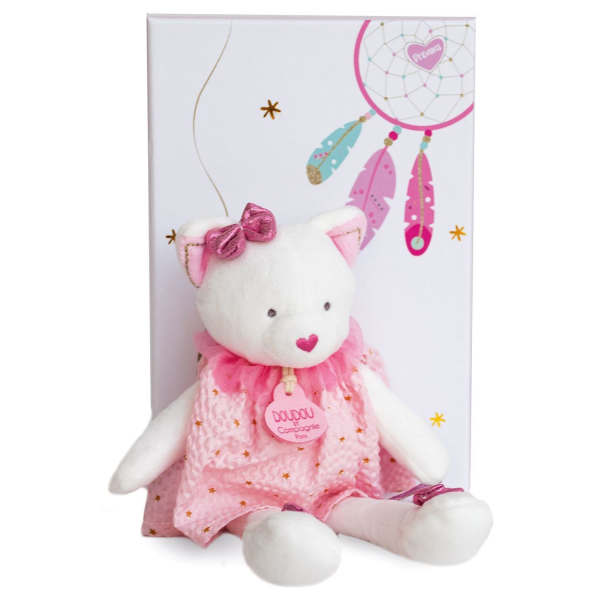 White teddy bear in a pink dress with a gift box behind it