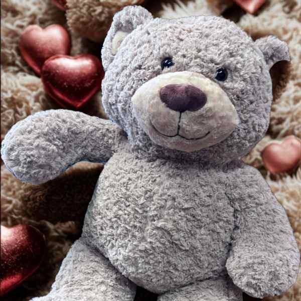 Gray plush teddy bear with metallic heart decorations