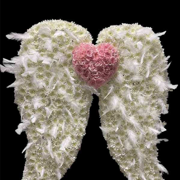 White floral angel wings with a pink rose heart center