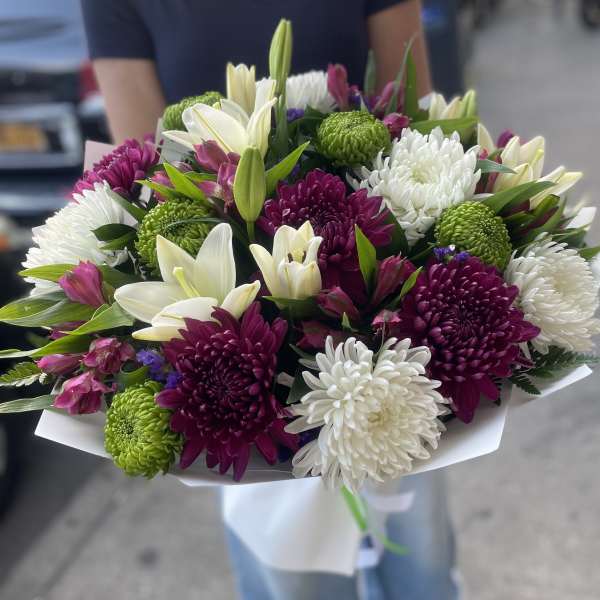Bouquet of white lilies, chrysanthemums, and purple flowers