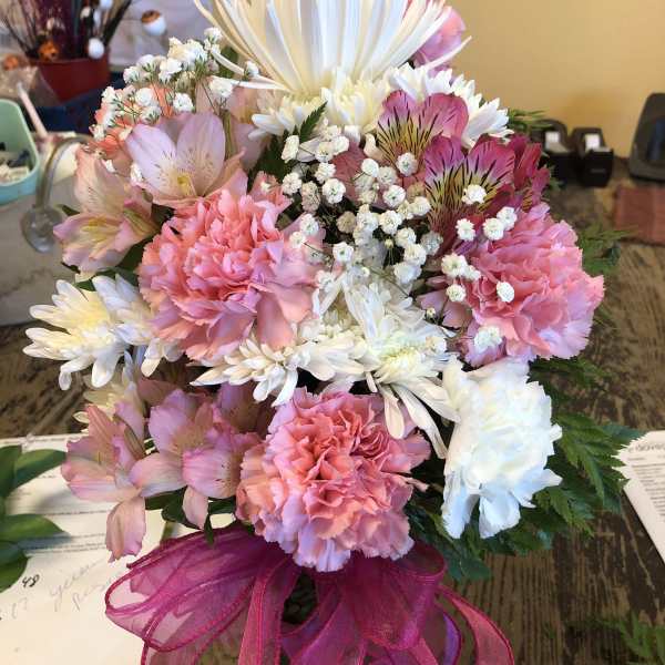 Pink and white mixed bouquet in a glass vase with a magenta ribbon