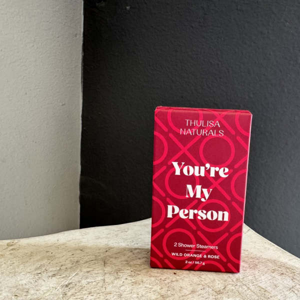 Red gift box labeled "You're My Person" on a tabletop