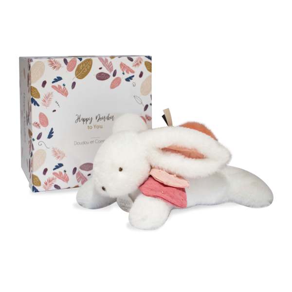 Plush white bunny with a pink outfit beside a patterned gift box