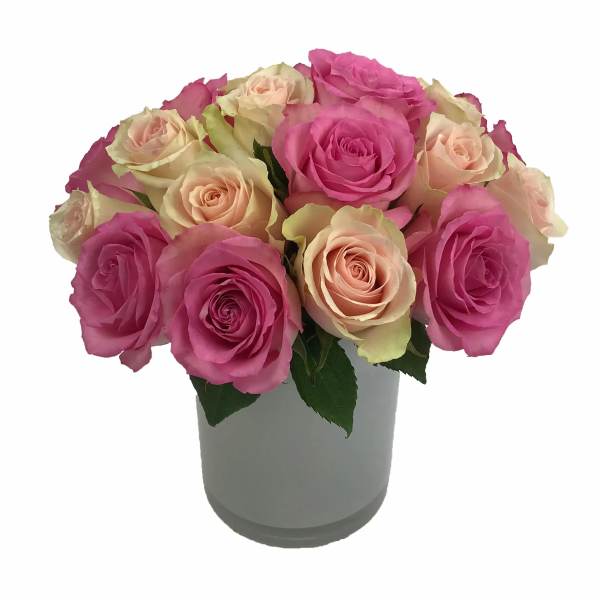 Pink and peach roses arranged in a gray vase