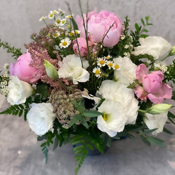 Bouquet of pink and white flowers with small daisy accents