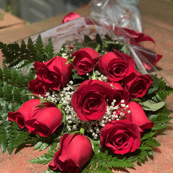 Bouquet of red roses with baby's breath and fern foliage
