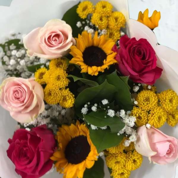 Bouquet of pink and red roses with sunflowers and yellow mums