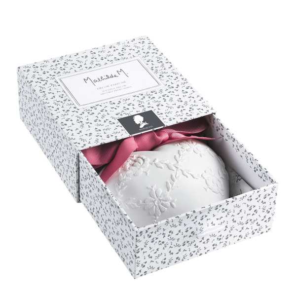 Decorative gift box with a pink ribbon and white embroidered item inside
