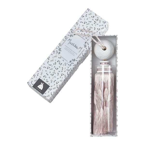Decorative perfume bottle with tassel in a patterned gift box