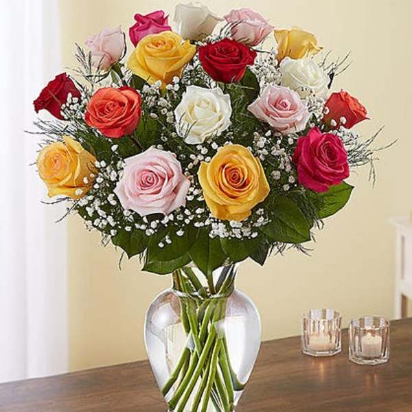 Bouquet of multicolored roses in a clear glass vase