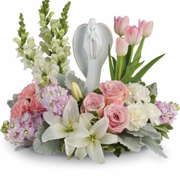 Pastel floral arrangement with angel figurine and tulips