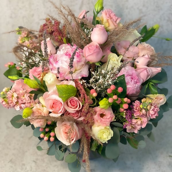 Bouquet of pink roses and mixed pastel flowers with eucalyptus