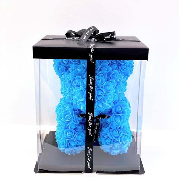 Blue rose teddy bear in a clear gift box with a black ribbon