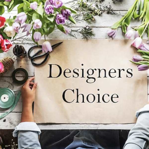 Tulips and floral supplies arranged around a sign reading Designers Choice