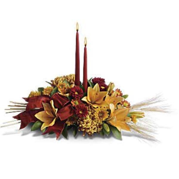 Autumn floral centerpiece with two burgundy taper candles