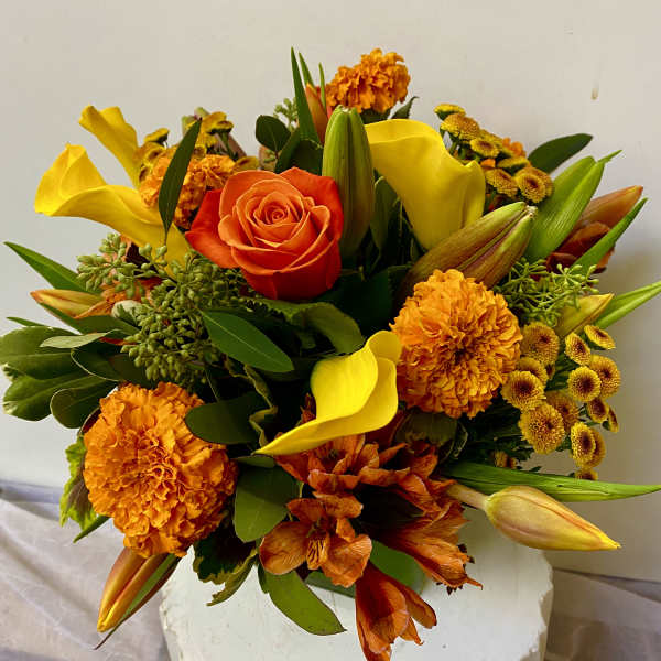 Orange and yellow bouquet with roses, calla lilies, and marigolds