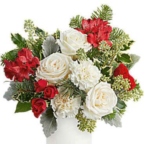 Red and white roses arranged in a white vase