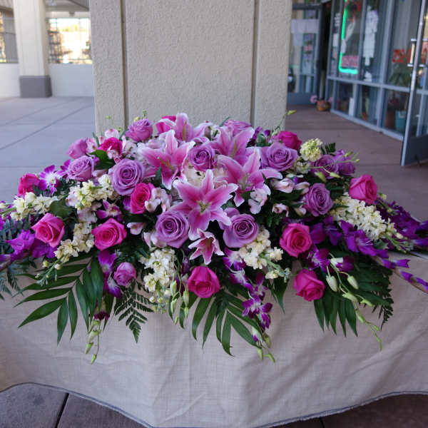 Large pink and purple floral arrangement on a table