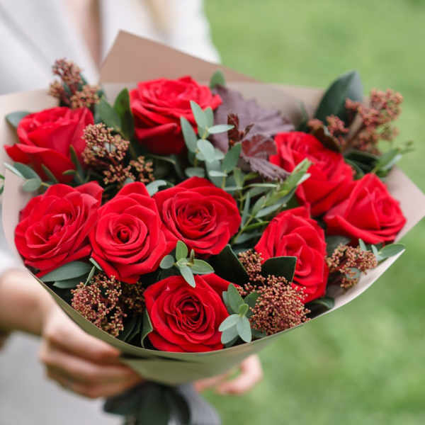 Bouquet of red roses with greenery and small filler flowers