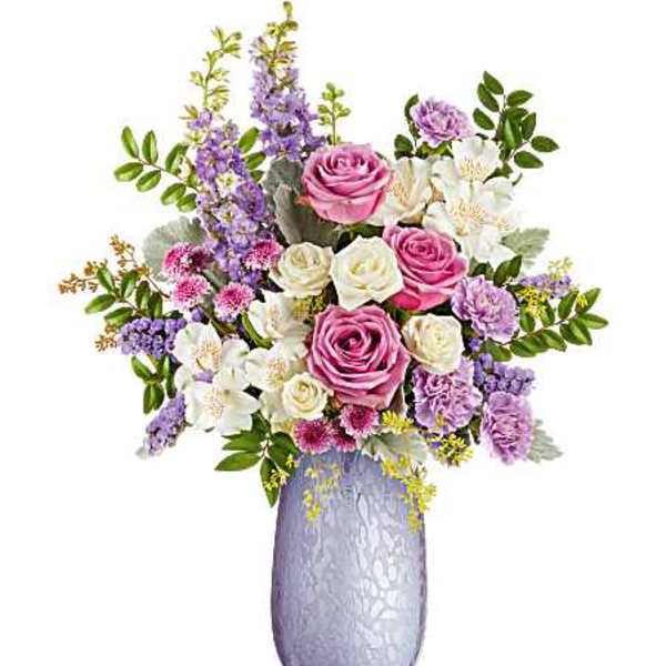 Pink and white roses with purple flowers in a lavender vase