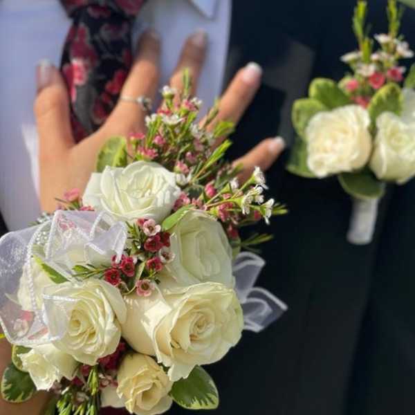 White rose bouquet and matching boutonniere on a suit jacket