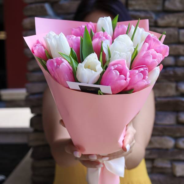 Pink and white tulip bouquet wrapped in pink paper