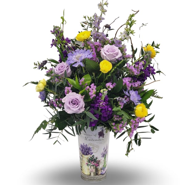 Lavender and yellow flower arrangement in a decorative vase