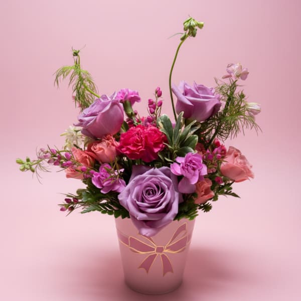 Pink and lavender flower arrangement in a decorative vase
