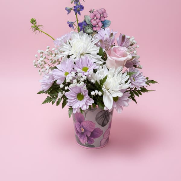 Pink and white mixed bouquet in a floral-patterned vase