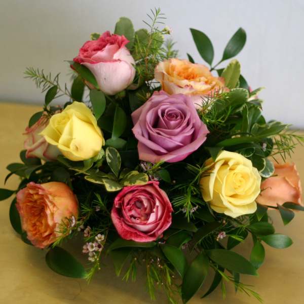 Mixed bouquet of roses in pink, yellow, peach, and lavender tones