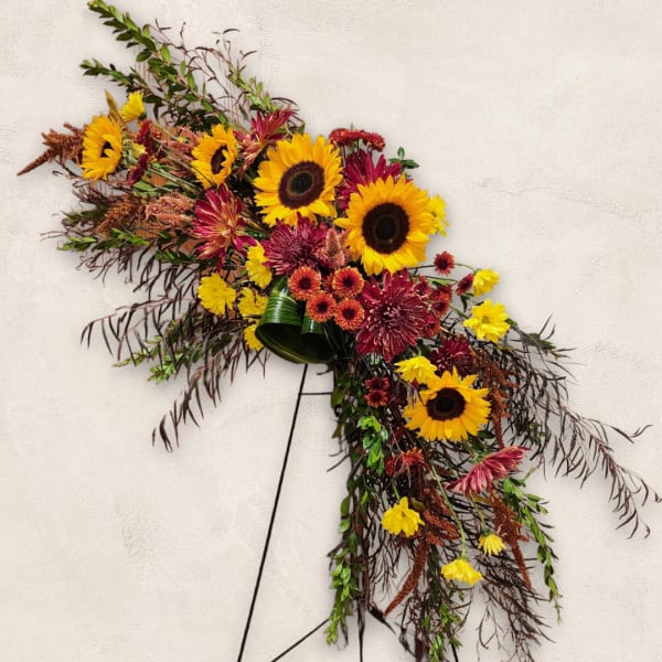 Large sunflower and chrysanthemum spray on a stand