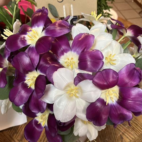 Bouquet of purple and white tulips with yellow centers