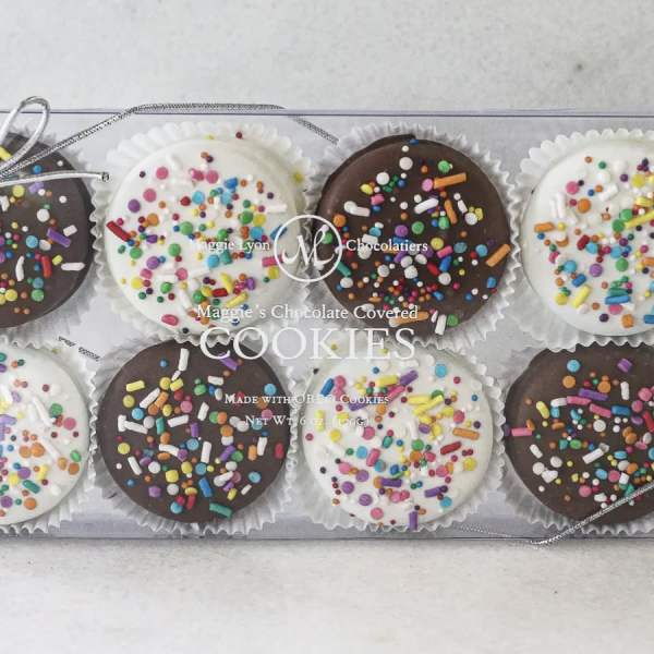 Box of chocolate-covered cookies with colorful sprinkles