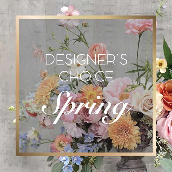 Pastel spring floral arrangement with roses, dahlias, and blue flowers