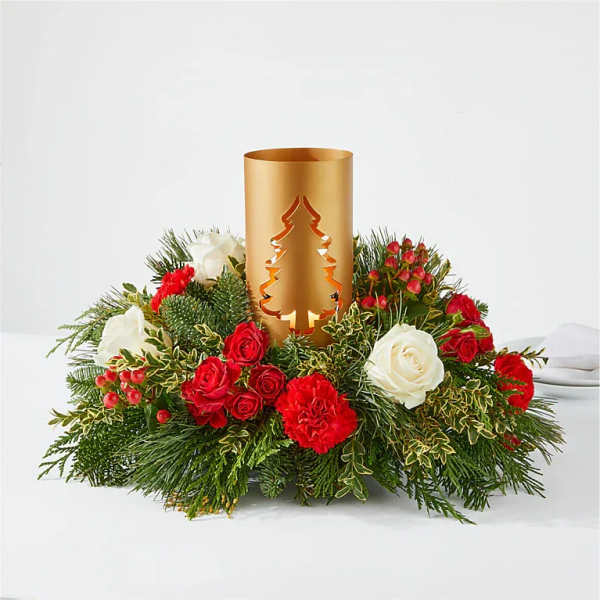 Holiday centerpiece with red and white flowers around a gold candle holder