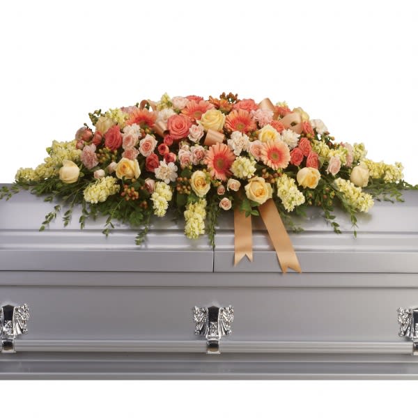 Pastel floral casket spray with roses and gerbera daisies