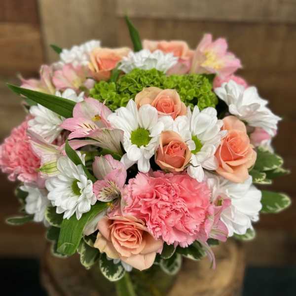 Bouquet of pink roses, carnations, and white daisies