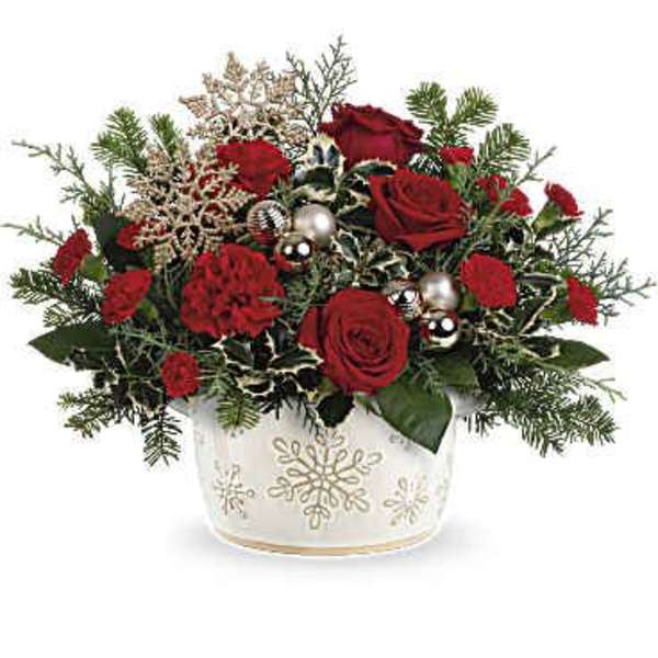 Red roses and carnations in a white snowflake vase