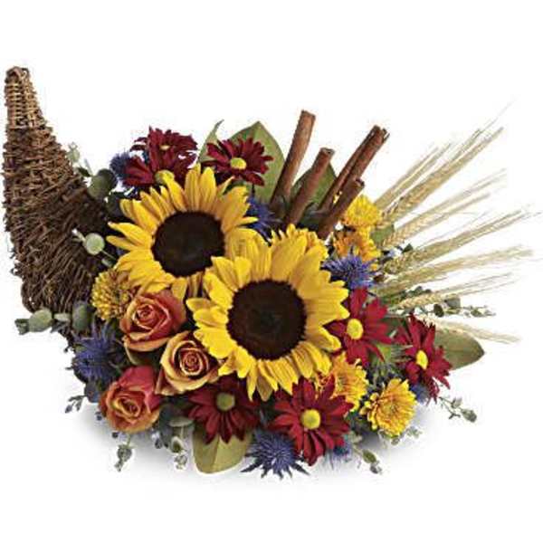Sunflower bouquet with roses and daisies in a woven basket