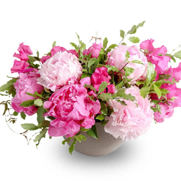 Pink peonies arranged in a low gray bowl vase