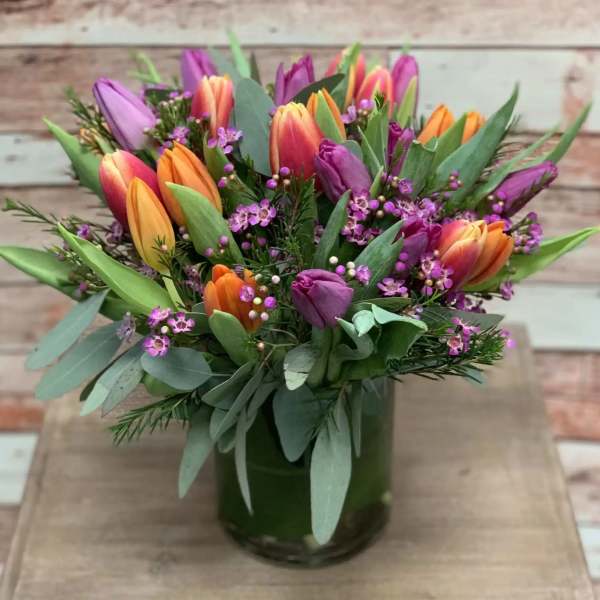 Bouquet of multicolored tulips in a glass vase