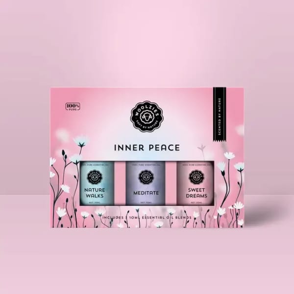 Pink boxed gift set of three essential oil blends labeled Nature Walks, Meditate, and Sweet Dreams