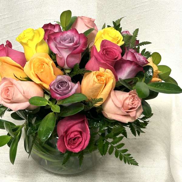 Bouquet of multicolored roses in a clear glass vase