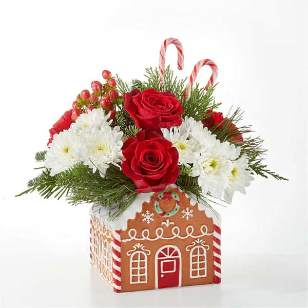 Christmas bouquet in a gingerbread house container with red roses and white daisies