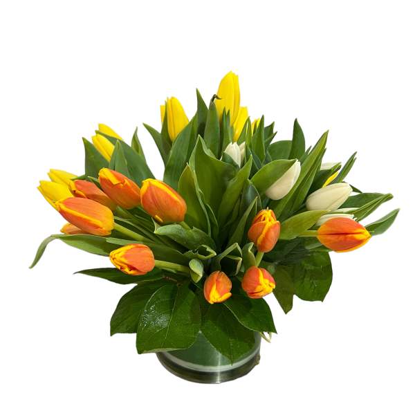 Bouquet of yellow and orange tulips in a glass vase