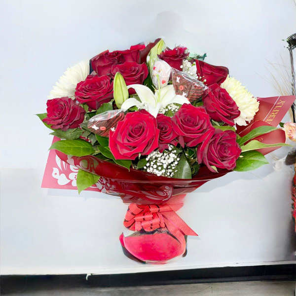 Bouquet of red roses with white lilies in red wrapping