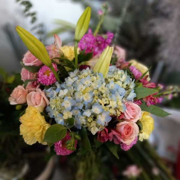 Mixed bouquet with blue hydrangea, pink roses, and yellow lilies