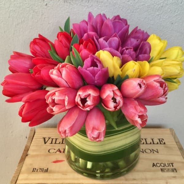 Bouquet of multicolored tulips in a glass vase